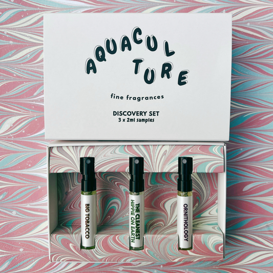 Aquaculture fine fragrances discovery set with three sample bottles on a marbled background